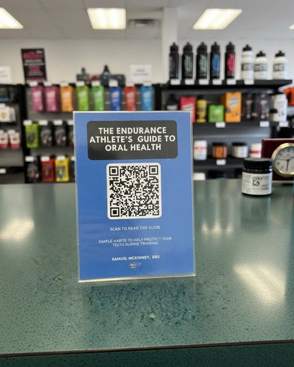 Blue sign with QR code on a counter in a store setting